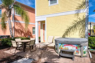 a patio with a fish tank and a table and chairs at Inviting Cottage With Private Hot Tub Near Disney With Margaritaville Resort & Island H2O Access - 8072Dr in Orlando