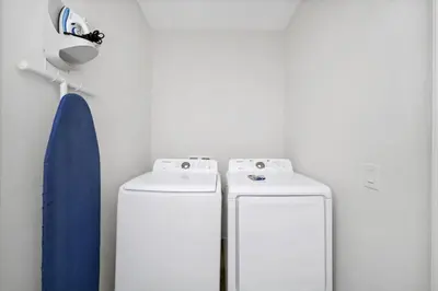 two white refrigerators in a room with a wall at Dreamy Cottage With Private Pool Near Disney With Margaritaville Resort & Island H2O Access - 8082Kd in Orlando