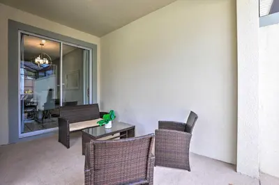 a dining room with wicker chairs and a table at 5 Mi to Disney Chic Townhome with Community Perks! in Kissimmee