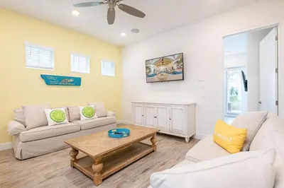 a living room with a couch and a coffee table at Sunny Cottage Near Disney With Margaritaville Resort & Island H20 Waterpark Access - 3004Sr in Orlando