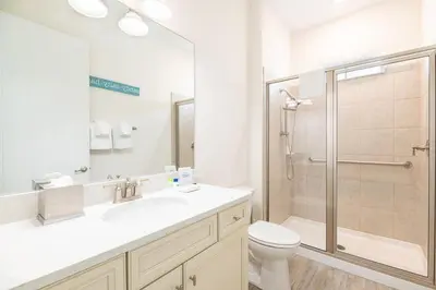 a bathroom with a shower and a toilet and a sink at Sunny Cottage Near Disney With Margaritaville Resort & Island H20 Waterpark Access - 3004Sr in Orlando