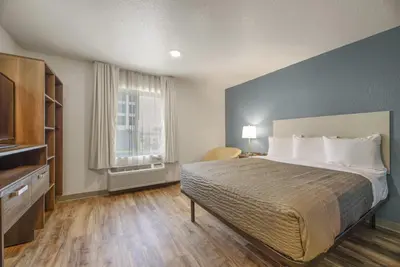 a bedroom with a large bed and a window at WoodSpring Suites Orlando I-4 & Convention Center in Orlando