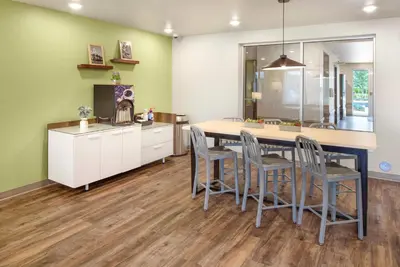 a kitchen with a table and chairs in a room at WoodSpring Suites Orlando I-4 & Convention Center in Orlando