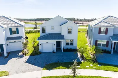 an aerial view of a white house at 5 bedroom home is ideal for an elegant vacation villa in Kissimmee