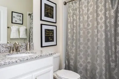 a bathroom with a shower curtain and a toilet at 5 bedroom home is ideal for an elegant vacation villa in Kissimmee