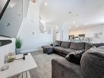 a living room with a couch and a table at Amazing 6 Bed Disney Dream Getaway in Windsor Palm villa in Kissimmee
