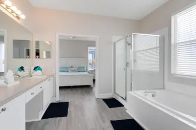 a white bathroom with a tub and a shower at Amazing 6 Bed Disney Dream Getaway in Windsor Palm villa in Kissimmee