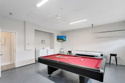 a ping pong table in a room with a pool at Amazing 6 Bed Disney Dream Getaway in Windsor Palm villa in Kissimmee