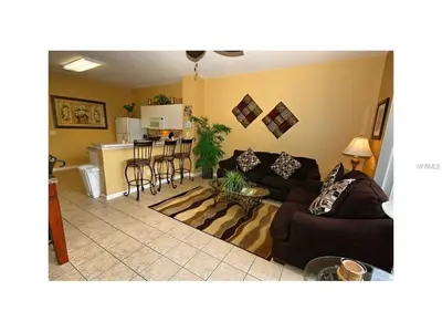 a living room with a couch and a kitchen at 3 Bedroom,3 Bath Townhouse in Gate Resort townhouse in Kissimmee