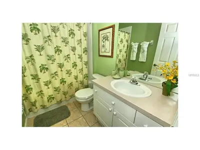 a bathroom with a sink and a toilet and a shower curtain at 3 Bedroom,3 Bath Townhouse in Gate Resort townhouse in Kissimmee
