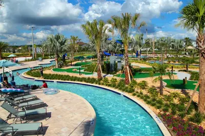 a pool at a resort with chairs and palm trees at Stunning 2Bd Apto Close to Disney @ Storey Lake 105P 3171 in Kissimmee