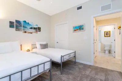 a bedroom with two beds and a bathroom at Stunning 2Bd Apto Close to Disney @ Storey Lake 105P 3171 in Kissimmee
