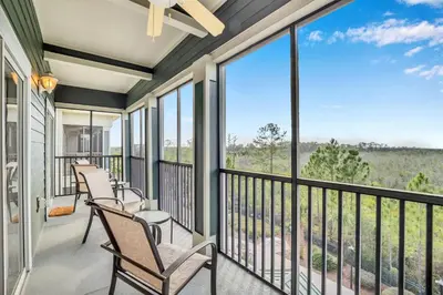 a balcony with chairs and windows with a view at -Relaxing 3BR Near Disney - Pool in Orlando