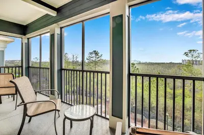 a screened porch with chairs and a table and windows at -Relaxing 3BR Near Disney - Pool in Orlando