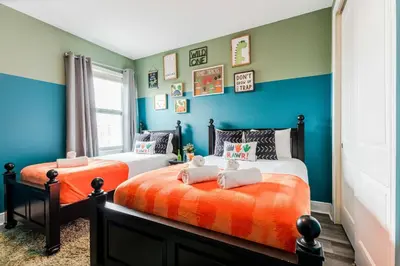 two beds in a room with blue and green walls at Encore Resort 6 Bedroom Home with Pool 2300 in Orlando