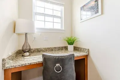 a chair sitting at a desk in a room with a window at Encore Resort 6 Bedroom Home with Pool 2300 in Orlando