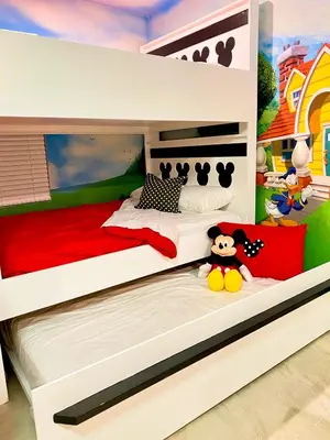a bunk bed in a childs bedroom with a toy at Happiest House on Earth near Disney World 9 Bedroom, Pool, Theater, Gameroom, Mickey Bunk room with Twisty Slide in Storey Lake in Kissimmee