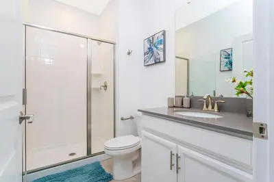 a bathroom with a shower and a toilet and a sink at Gorgeous 4 Bd Close to Disney w/ Pool @ Storey Lake Resort 4245 in Kissimmee