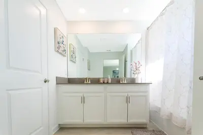 a bathroom with a sink and a mirror at Gorgeous 4 Bd Close to Disney w/ Pool @ Storey Lake Resort 4245 in Kissimmee