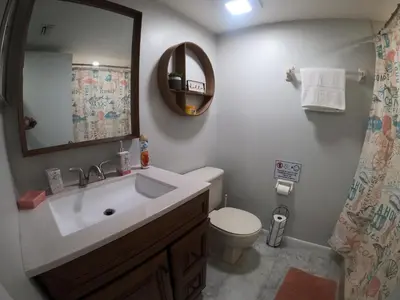 a bathroom with a sink and a toilet and a mirror at 3697 Orlando Vacational Apartment in Orlando