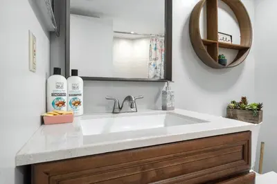 a bathroom with a white sink and a mirror at 3697 Orlando Vacational Apartment in Orlando