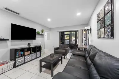 a living room with a couch and a flat screen tv at 3697 Orlando Vacational Apartment in Orlando