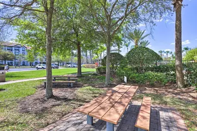 a picnic table in a park with trees at NEW! Luxury Condo, Min to DisneyConvention Center in Orlando