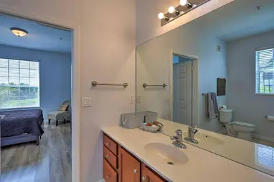 a bathroom with a sink and a mirror at NEW! Luxury Condo, Min to DisneyConvention Center in Orlando