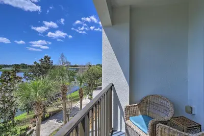 a balcony with a view of a river and palm trees at NEW! Luxury Condo, Min to DisneyConvention Center in Orlando