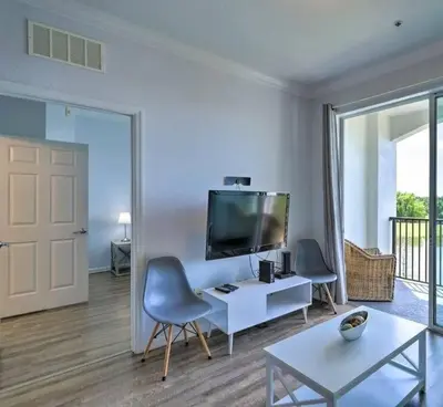 a living room with a tv and a table and chairs at SeaworldDisneyUniversal Villa 5 beds 3 bed2bath in Orlando
