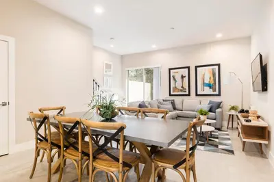 a dining room and living room with a table and chairs at Stylish Family Villa 5min Disney BBQ 1804ft in Orlando
