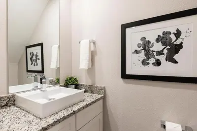a bathroom with a white sink and a mirror at Stylish Family Villa 5min Disney BBQ 1804ft in Orlando