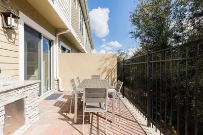 a patio with a table and chairs on a balcony at Stylish Family Villa 5min Disney BBQ 1804ft in Orlando