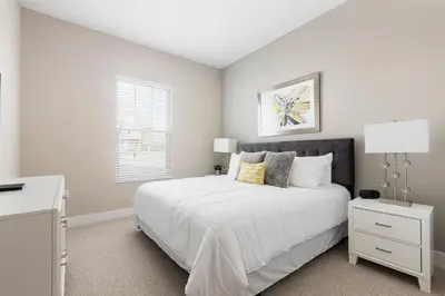 a bedroom with a large white bed and a window at Stylish Family Villa 5min Disney BBQ 1804ft in Orlando