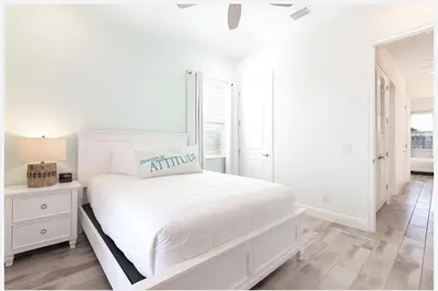 a white bedroom with a white bed and a window at ZAY & ZAC’S SHAKE SHACK in Orlando