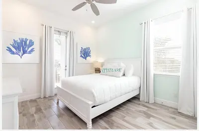 a white bedroom with a bed and a ceiling fan at ZAY & ZAC’S SHAKE SHACK in Orlando