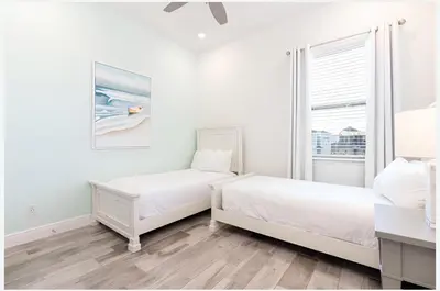 a white bedroom with two beds and a window at ZAY & ZAC’S SHAKE SHACK in Orlando