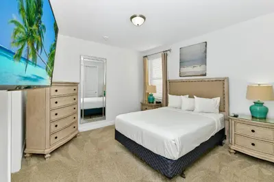 a bedroom with a white bed and a palm tree at Marvelous Home Near Disney With Private Pool And Waterpark & Resort Access At Encore Resorts Reunion - 250Cl in Kissimmee