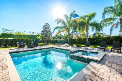 a swimming pool in a yard with palm trees at Marvelous Home Near Disney With Private Pool And Waterpark & Resort Access At Encore Resorts Reunion - 250Cl in Kissimmee