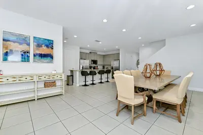 a kitchen and dining room with a table and chairs at Marvelous Home Near Disney With Private Pool And Waterpark & Resort Access At Encore Resorts Reunion - 250Cl in Kissimmee