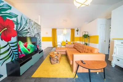 a living room with a couch and a flat screen tv at Newly Updated 3 Bedroom Home in Kissimmee