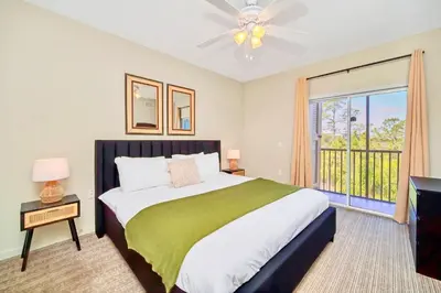 a bedroom with a large bed and a window at Stunning 2BR Condo with Pool, near Disney! in Orlando