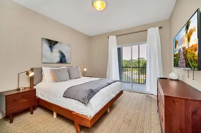 a bedroom with a bed and a dresser and a window at Bright 3BR Condo With Pool, Close to Disney! in Orlando
