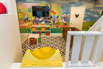a room with a toy room with a mickey mouse mural at Mickey Mouse ClubHouse 8min Disneyworld Pool Spa Sleeps 20 in Kissimmee