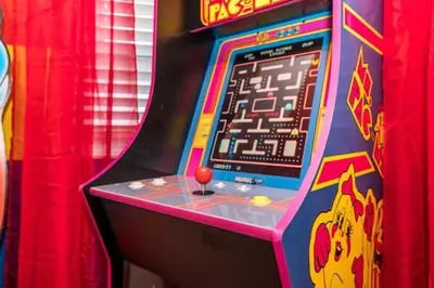 a video game machine with a red ball on it at Disney Decorated Home 8min Disneyworld Pool/Spa Sleeps 22 in Kissimmee