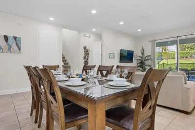 a dining room with a table and chairs at 7500 Marker av in Orlando