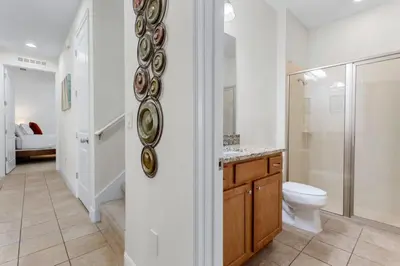 a white bathroom with a toilet and a shower at 7500 Marker av in Orlando