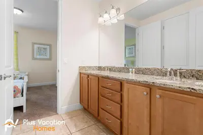 a bathroom with two sinks and a large mirror at 361 Pendant ct in Orlando