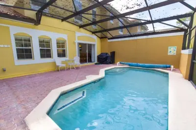 a large swimming pool in a room with a building at Peaceful Quiet Pool Home 5 min from Disney! townhouse in Orlando