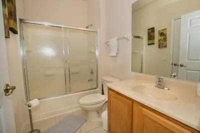 a bathroom with a shower and a toilet and a sink at Peaceful Quiet Pool Home 5 min from Disney! townhouse in Orlando